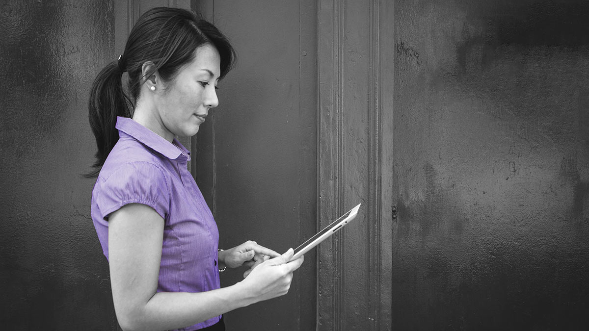 Woman checking her RRSP balance on a tablet using online banking