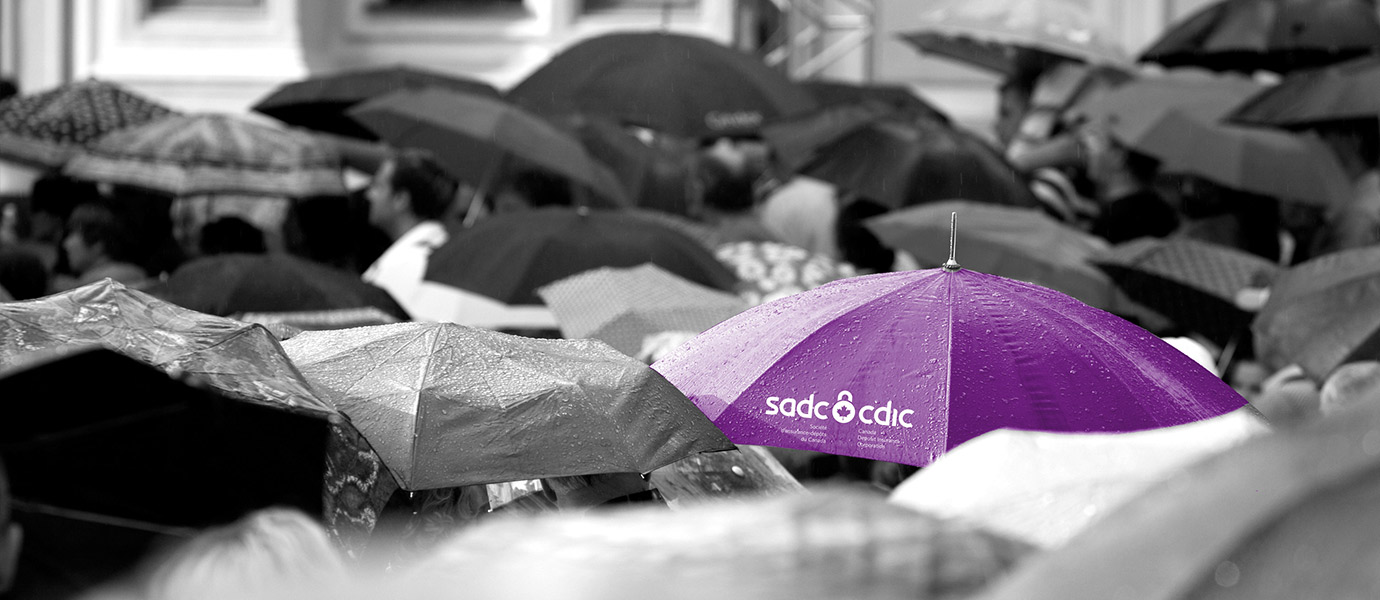 A purple umbrella with the CDIC / SADC logo on it