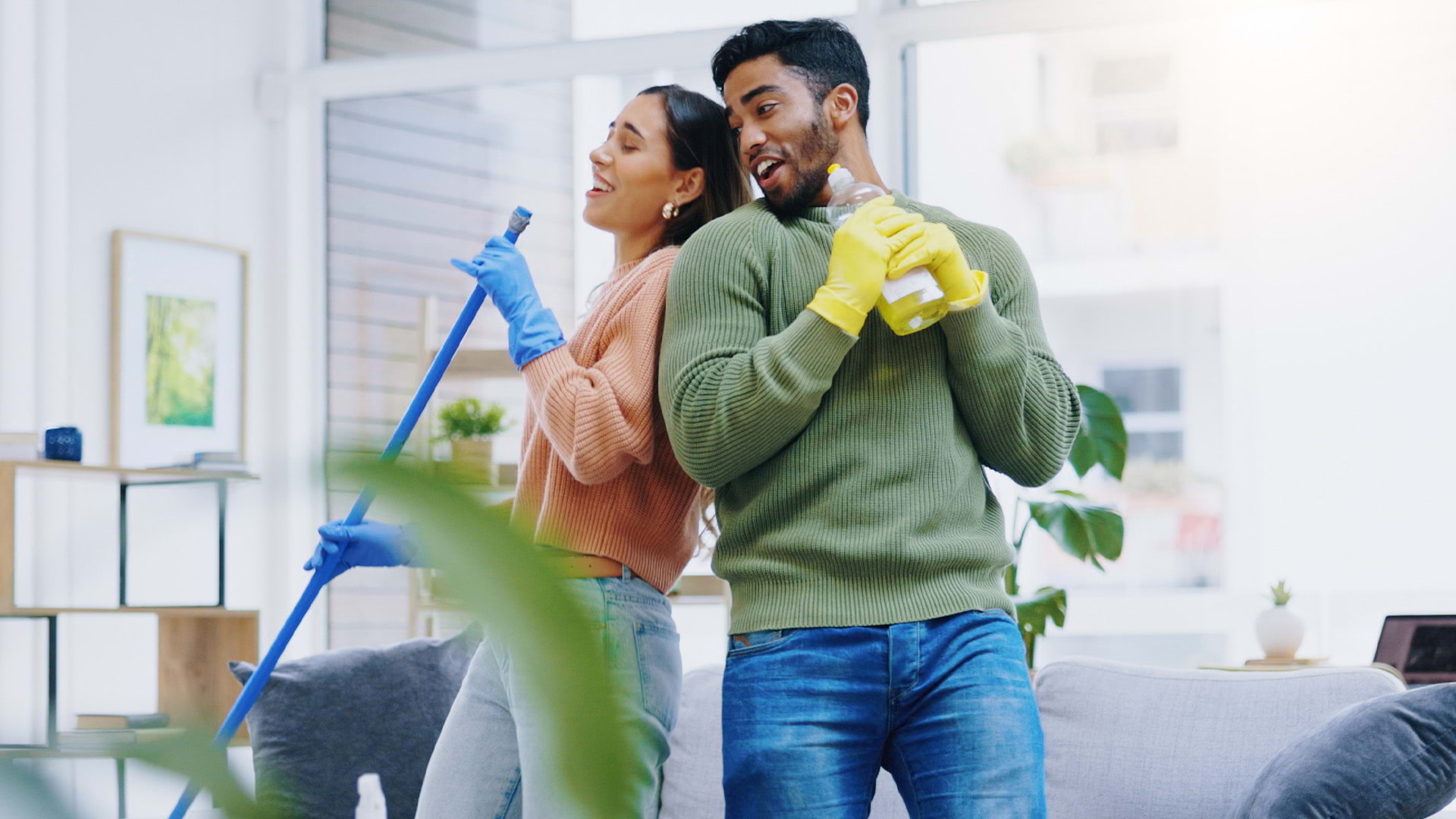 Un homme et une femme s'attaquant à des tâches de nettoyage tout en s'amusant à danser.